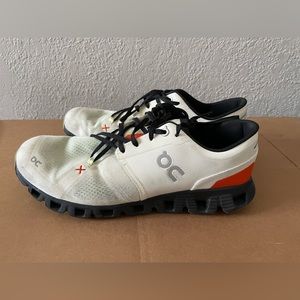 On running white, red, black lace up sneakers. Lightly used in great condition!